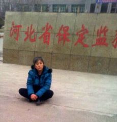 悲愤的郑祥星妻子孙素云坐在保定监狱外冰冷水泥地上,向社会呼救