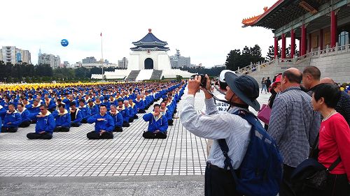 图1-3:自由广场前法轮功学员举办的大型排字弘法活动,吸引台湾民众及外国观光客驻足观看