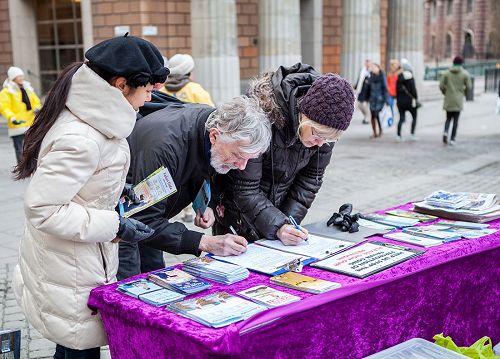 '图4,明白真相的人们主动签名,支持法轮功学员反迫害。'