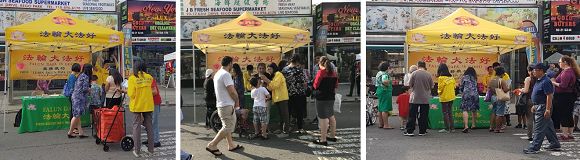 '图6:人们围着法轮功展位了解如何修炼法轮功'