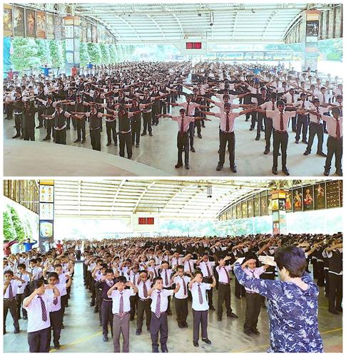 图2:骄狄英语中学全校六百多名师生集体炼法轮功功法。