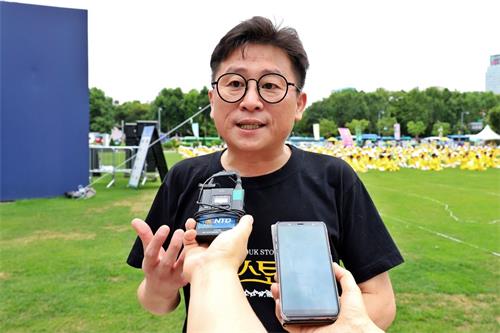 '图16:音乐剧《耀德故事》的脱北者导演郑成山在接受采访。'