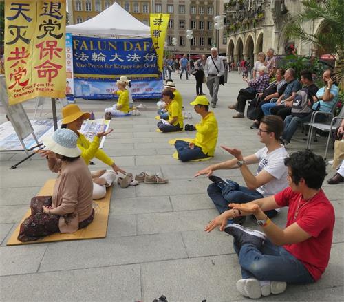 '图3:有人当场跟法轮功学员学炼功法。'