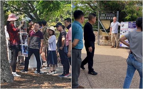 '图:中国游客驻足认真浏览法轮功学员举着真相展板上的内容'
