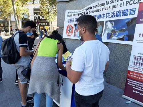 '图1~2:巴塞罗那市中心,民众签名谴责中共迫害法轮功。'