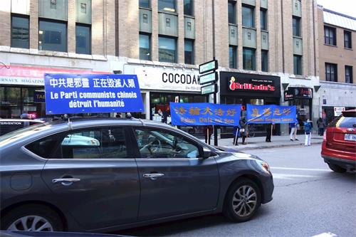 '图1:法轮功学员在中领馆前的汽车游行'