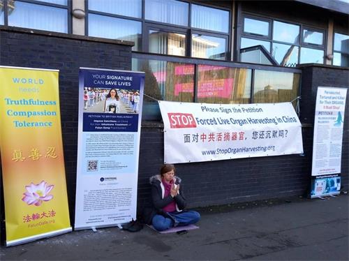 '图2:法轮功学员在11月2日场外的展位醒目祥和'