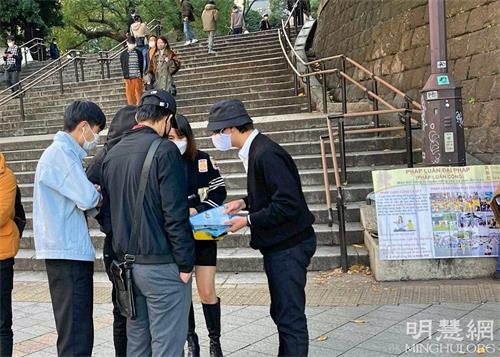 '图1~3:二零二一年十二月十一日和十二日,法轮功学员在越南节活动期间,设立真相点,传播法轮功的真相。了解真相后的民众签名支持全球诉江。'