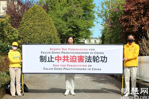 '图1:法轮功学员在伯尔尼中共使馆前宣读中文及德文公开信,要求停止迫害'