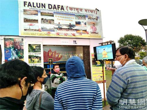 '图2:法轮功学员(右一)在介绍法轮功功法'