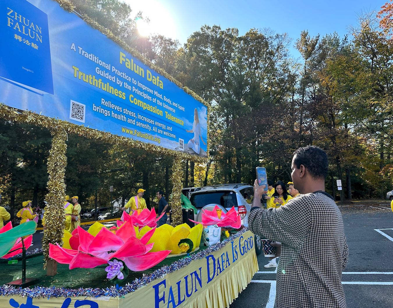 '图6:弗吉尼亚州居民尤哈尼斯(Yohanes)用手机拍下了花车上的展板,渴望了解法轮大法。'