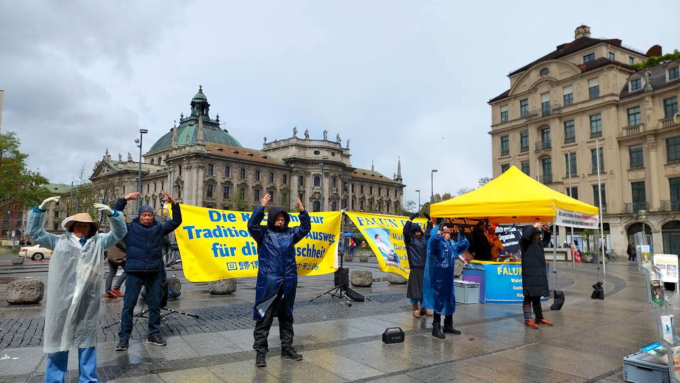 '图3:法轮功学员顶着风雨在慕尼黑卡尔斯广场(Karlsplatz)展示功法。'